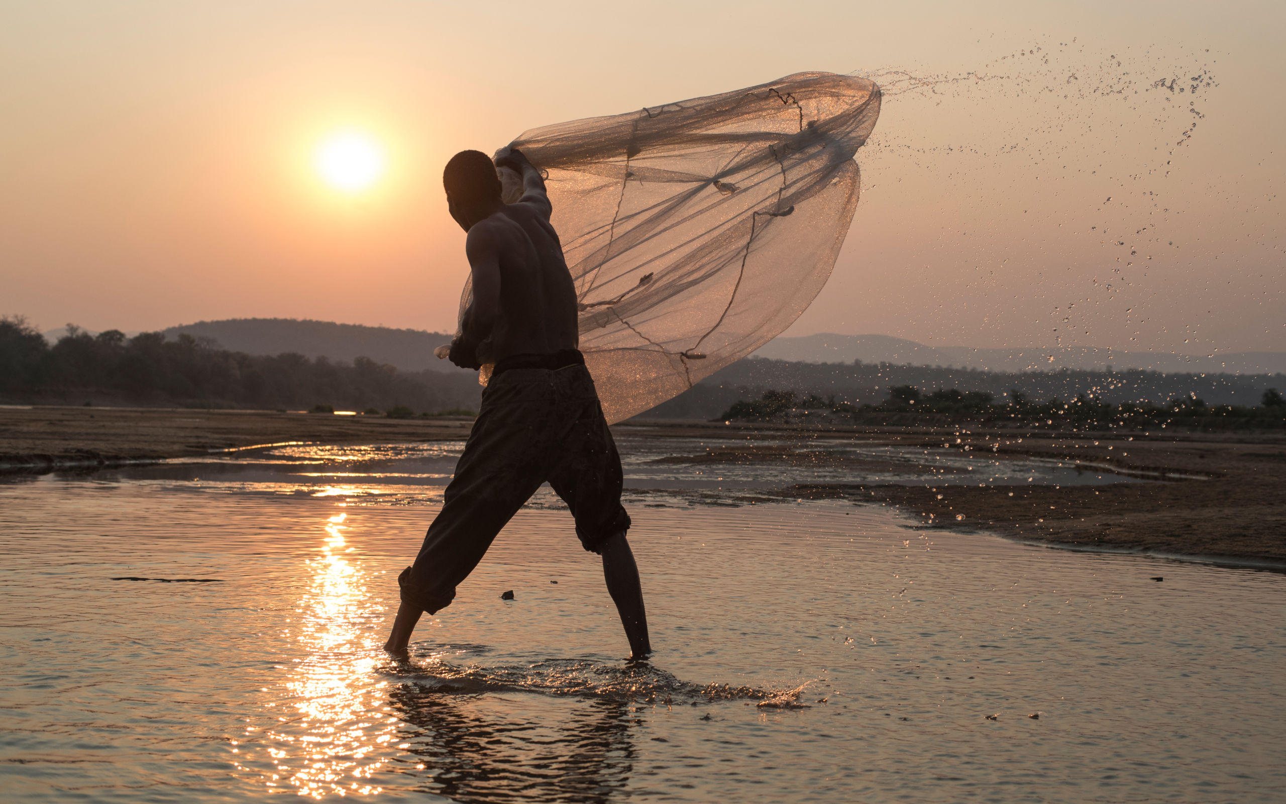 A local fisherman casting his net -Luangwa River, Zambia